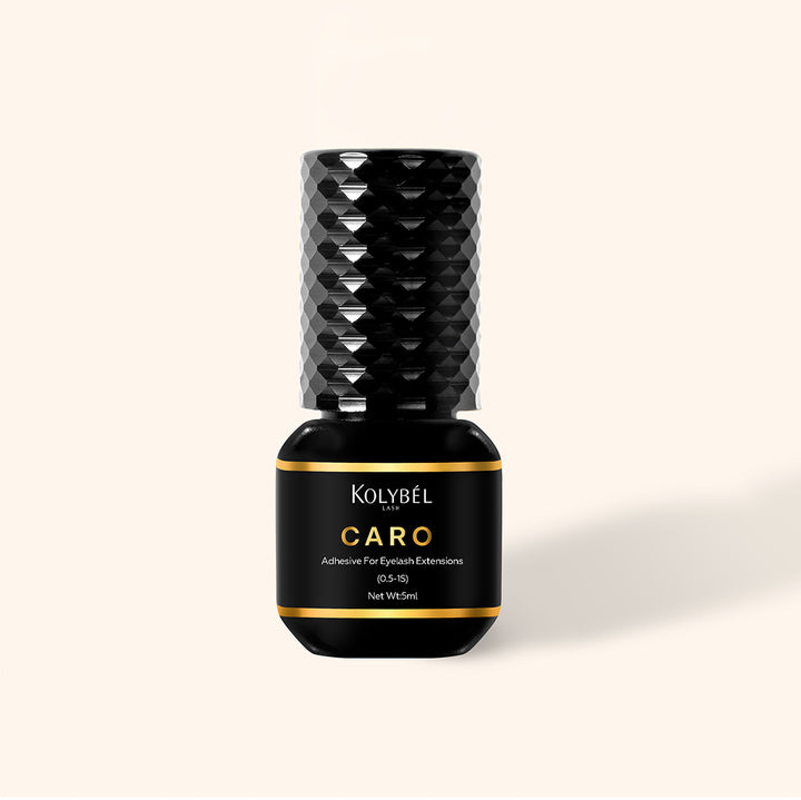0.5-1 Second CARO Adhesive Eyelash Extension Glue (5ml) - Kolybel-This professional eyelash extension adhesive offers ultra-fast 0.5–1 second drying for efficient lash application and long-lasting wear. Its strong, semi-permanent bond provides up to 7–8 weeks of retention with a glossy black finish for a defined lash line.